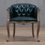 Willem Accent Chair in emerald leather with tufted back, brass nailheads, and carved light wood frame.