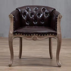Willem Accent Chair in classic brown leather with tufted back, brass studs, and distressed light wood frame.