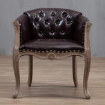 Willem Accent Chair in classic brown leather with tufted back, brass studs, and distressed light wood frame.