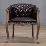 Willem Accent Chair in classic brown leather with tufted back, brass studs, and distressed light wood frame.