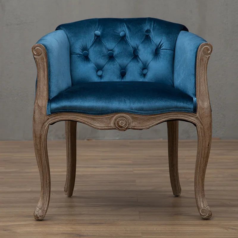 Willem Accent Chair in royal blue velvet with tufted back and carved light wood frame.