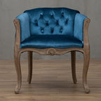 Willem Accent Chair in royal blue velvet with tufted back and carved light wood frame.