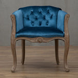 Willem Accent Chair in royal blue velvet with tufted back and carved light wood frame.