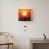 Horizon Wall Light, a square wall sconce with a sunset-inspired gradient and two hanging pull cords.