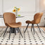 Lorca dining chair in brown faux leather with vertical channel tufting and black tapered legs.