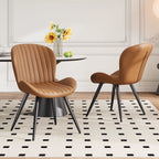 Lorca dining chair in brown faux leather with vertical channel tufting and black tapered legs.