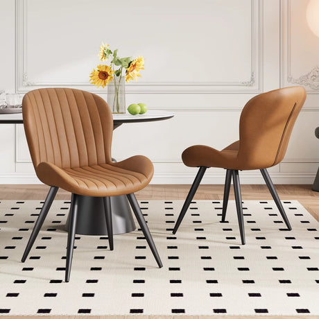 Lorca dining chair in brown faux leather with vertical channel tufting and black tapered legs.