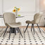 Lorca Dining Chair in beige fabric with vertical channel tufting and black tapered legs, shown in a dining room.
