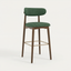 Norden Bar Stool, Forest green upholstered seat and back, dark wood frame, and brass footrest.