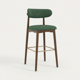 Norden Bar Stool, Forest green upholstered seat and back, dark wood frame, and brass footrest.