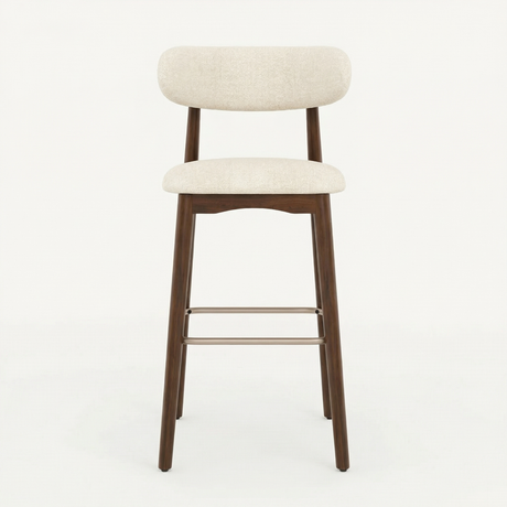 Norden Bar Stool with light beige upholstered seat and back, dark wood frame, and metal footrest.