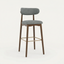 Norden Bar Stool, Slate Counter Stool with gray upholstered seat and back, dark wood frame, and brass footrest.