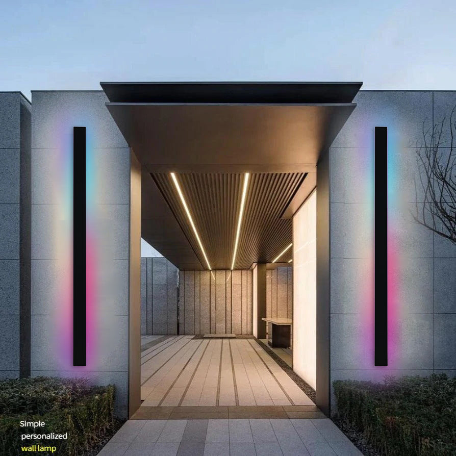 Parc Sconce outdoor wall light, black vertical fixture with RGB color-changing illumination on a modern building.