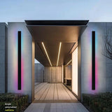 Parc Sconce outdoor wall light, black vertical fixture with RGB color-changing illumination on a modern building.