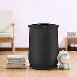 Black towel warming bucket with a round lid, next to stacked towels and a plush toy.