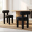 Rogolo dining chair, black velvet, with a rounded backrest and thick, cylindrical legs.