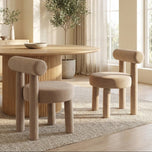 Rogolo dining chair in sand fabric, with a round seat and backrest, and thick cylindrical legs.